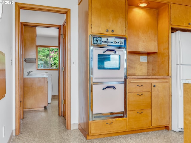 4915 Leif Erikson Dr, Astoria, OR 97103 - kitchen featuring white appliances, light flooring, baseboards, and light countertops