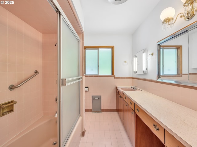 4915 Leif Erikson Dr, Astoria, OR 97103 - full bath with tile patterned floors, vanity, bath / shower combo with glass door, tile walls, and wainscoting