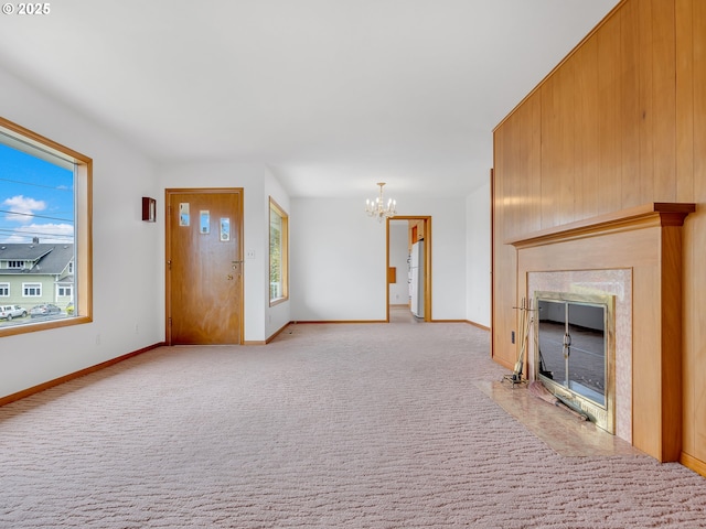 4915 Leif Erikson Dr, Astoria, OR 97103 - unfurnished living room with a chandelier, a high end fireplace, baseboards, and light carpet