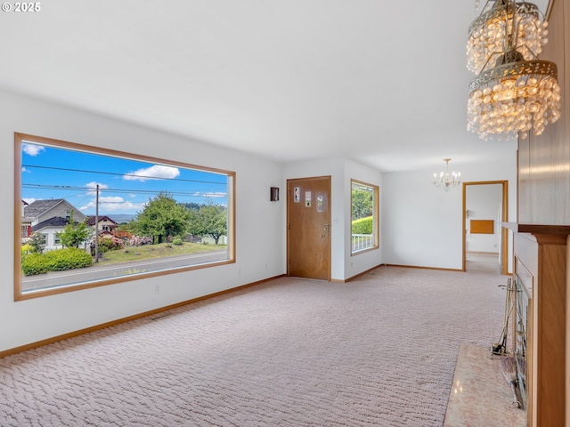 4915 Leif Erikson Dr, Astoria, OR 97103 - unfurnished living room featuring a chandelier, baseboards, and light carpet