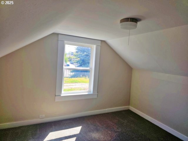967 NW 2nd St, Prineville, OR 97754 - additional living space with lofted ceiling and dark carpet