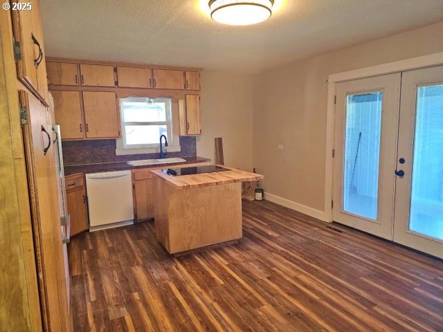 967 NW 2nd St, Prineville, OR 97754 - kitchen featuring dishwasher, french doors, dark wood finished floors, butcher block countertops, and black electric cooktop