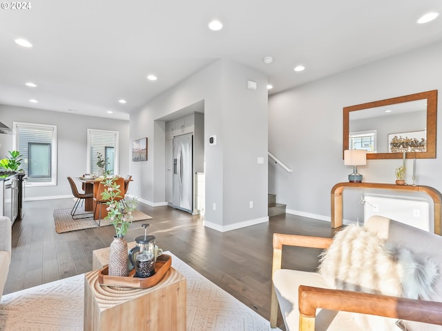 living room featuring stairs, dark wood-style flooring, baseboards, and recessed lighting