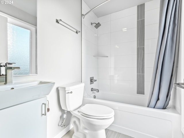 bathroom with shower / bath combo, vanity, and toilet