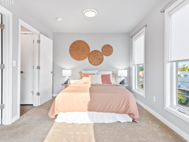 carpeted bedroom featuring baseboards