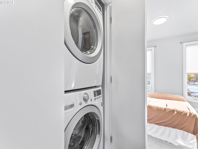 laundry area featuring laundry area and stacked washer and clothes dryer