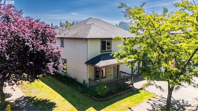 18450 SW Longacre St, Beaverton, OR 97003 - view of home's exterior featuring covered porch, roof with shingles, and a yard