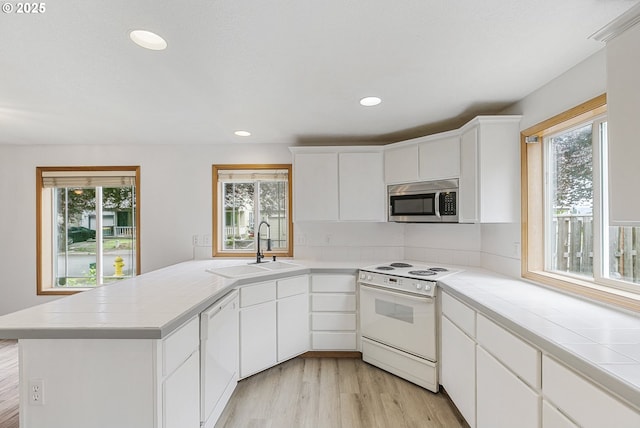 18450 SW Longacre St, Beaverton, OR 97003 - kitchen with white appliances, a sink, tile countertops, a peninsula, and recessed lighting