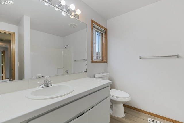 18450 SW Longacre St, Beaverton, OR 97003 - full bath with toilet, wood finished floors, vanity, a shower, and baseboards
