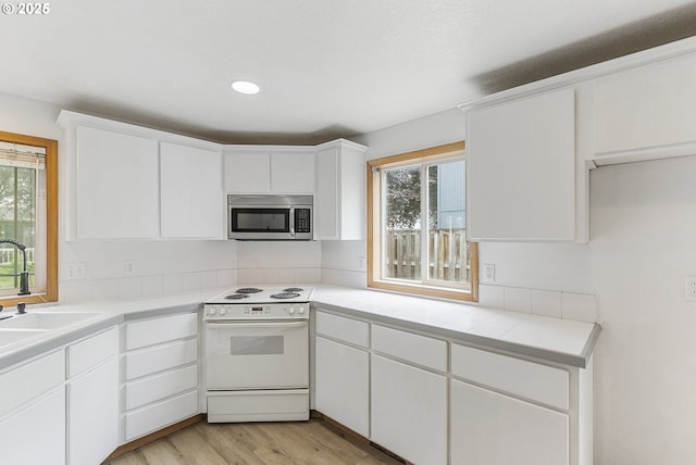 18450 SW Longacre St, Beaverton, OR 97003 - kitchen with stainless steel microwave, electric stove, healthy amount of natural light, and a sink