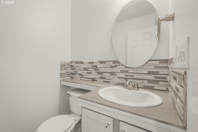 half bath with tasteful backsplash, vanity, and toilet
