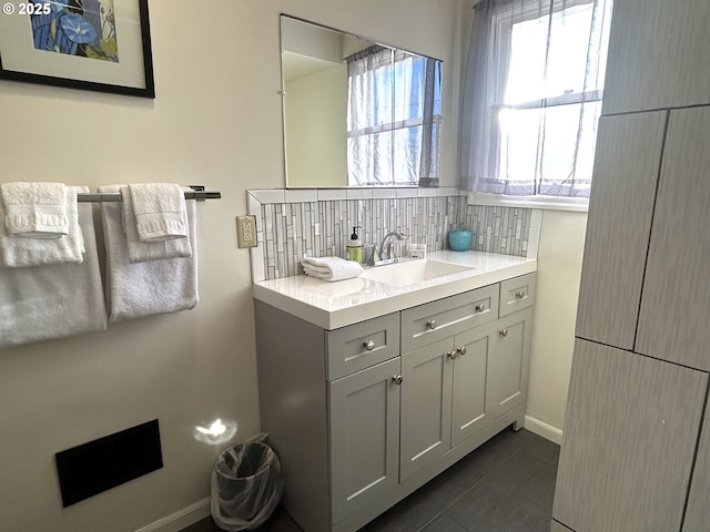 bathroom with tasteful backsplash and vanity