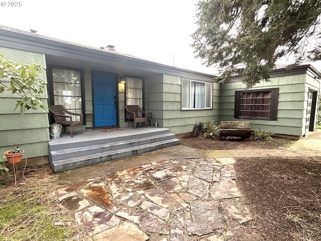 view of exterior entry featuring a patio area