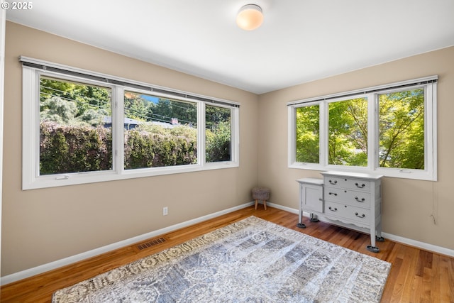 bedroom featuring baseboards and wood finished floors