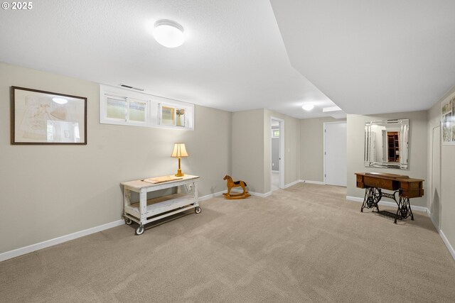 sitting room featuring carpet flooring and baseboards
