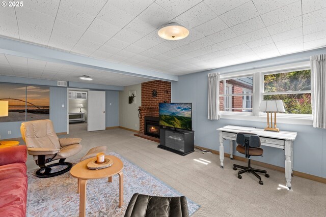 carpeted living area with baseboards and a brick fireplace
