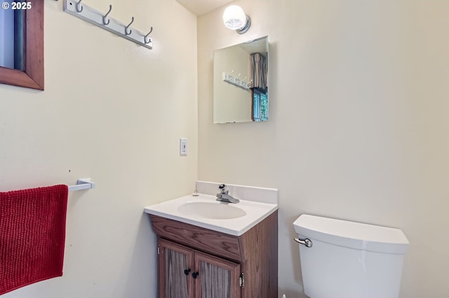 half bathroom with toilet and vanity