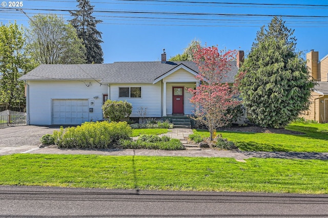 ranch-style home featuring fence, driveway, a front yard, and a garage