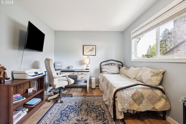 bedroom with wood finished floors