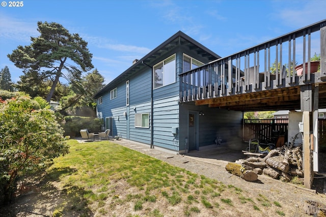 view of property exterior featuring a patio and a wooden deck