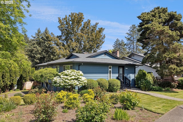 view of front of property featuring a chimney and roof with shingles