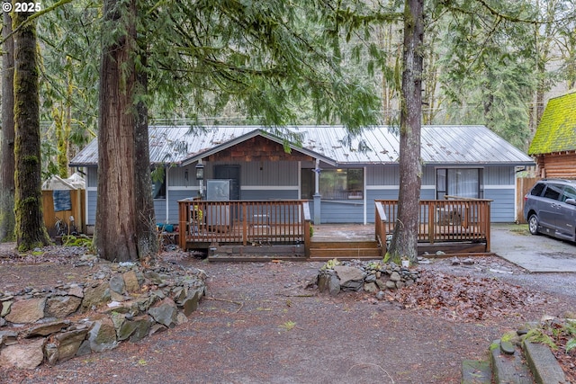 view of front of home with metal roof and a deck