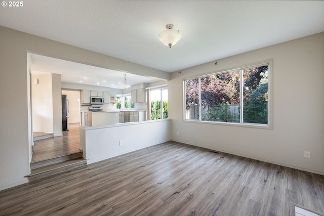 17510 NW Fieldstone Dr, Beaverton, OR 97006 - unfurnished living room featuring wood finished floors and baseboards