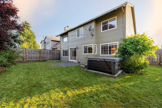 17510 NW Fieldstone Dr, Beaverton, OR 97006 - back of house with a hot tub, a fenced backyard, and a chimney
