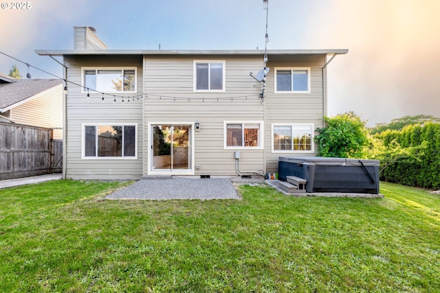 17510 NW Fieldstone Dr, Beaverton, OR 97006 - back of property featuring a hot tub, a fenced backyard, a chimney, and a patio