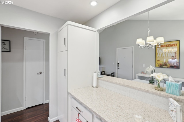 kitchen featuring white appliances, under cabinet range hood, a sink, tasteful backsplash, and white cabinets