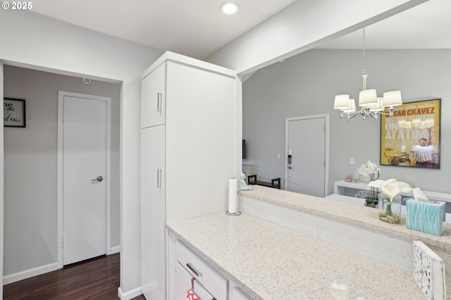 bathroom featuring wood-type flooring, a chandelier, and vaulted ceiling