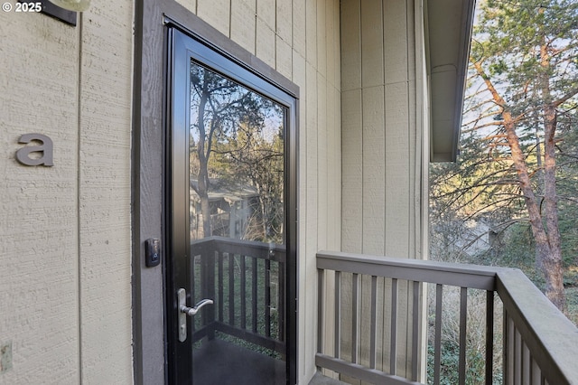 view of exterior entry featuring a balcony