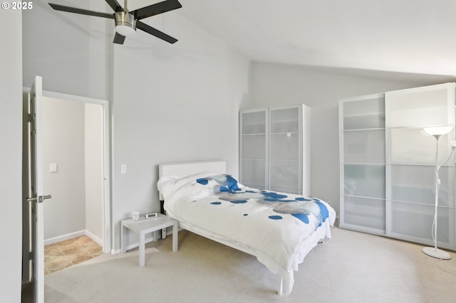 bedroom with ceiling fan, light colored carpet, and lofted ceiling