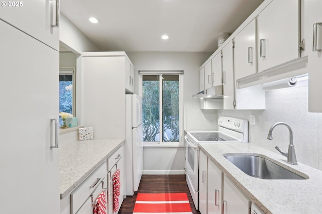 kitchen with sink, white appliances, white cabinetry, dark hardwood / wood-style floors, and decorative backsplash