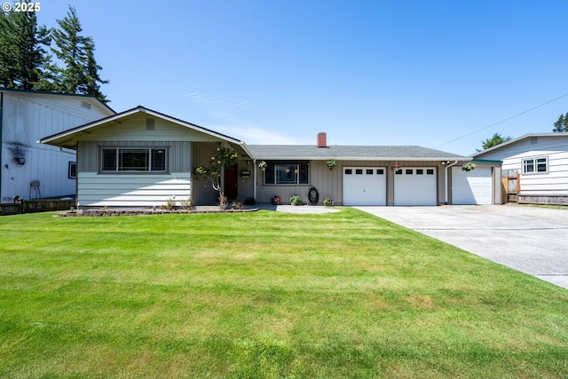 3840 Vista Dr, North Bend, OR 97459 - ranch-style house with an attached garage, concrete driveway, a chimney, and a front lawn