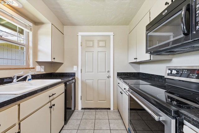 3840 Vista Dr, North Bend, OR 97459 - kitchen with black appliances, white cabinetry, and light tile patterned flooring