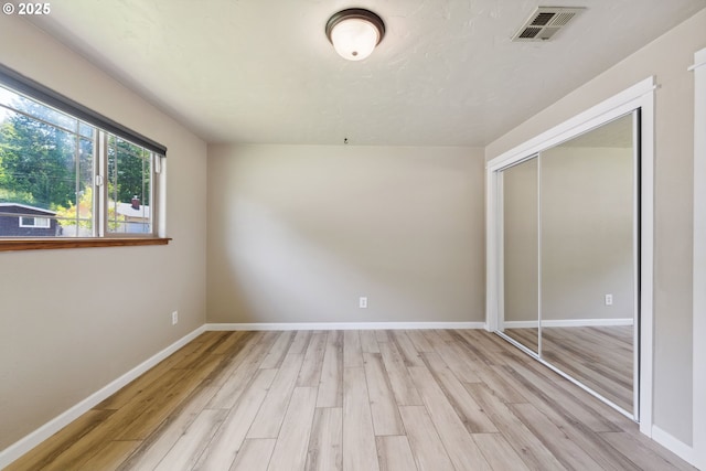 3840 Vista Dr, North Bend, OR 97459 - unfurnished bedroom with light wood-type flooring and a closet