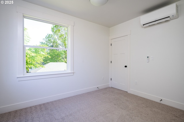 carpeted spare room with baseboards and a wall mounted air conditioner