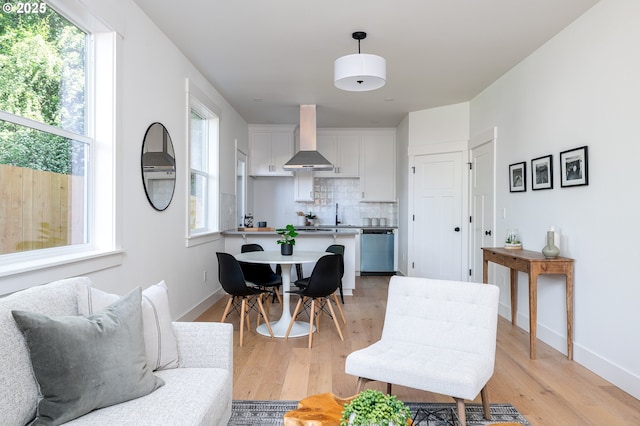 living room featuring baseboards and light wood-style flooring