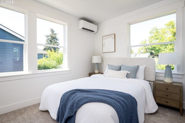 bedroom with baseboards, carpet flooring, and a wall mounted AC