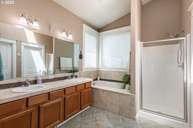 bathroom with a sink, a bath, vaulted ceiling, and a shower stall
