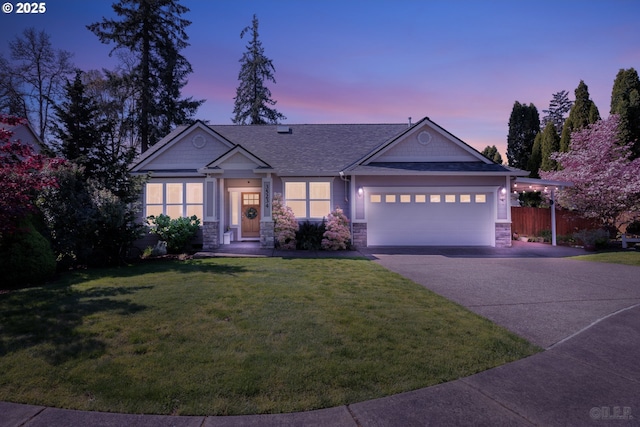 view of front facade with a garage, a front yard, driveway, and stone siding