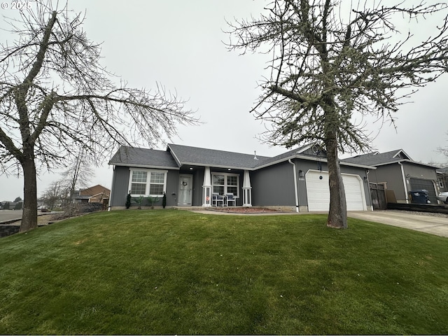 view of front of home with a front yard and a garage