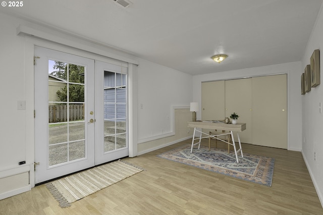 home office featuring french doors, baseboards, and wood finished floors