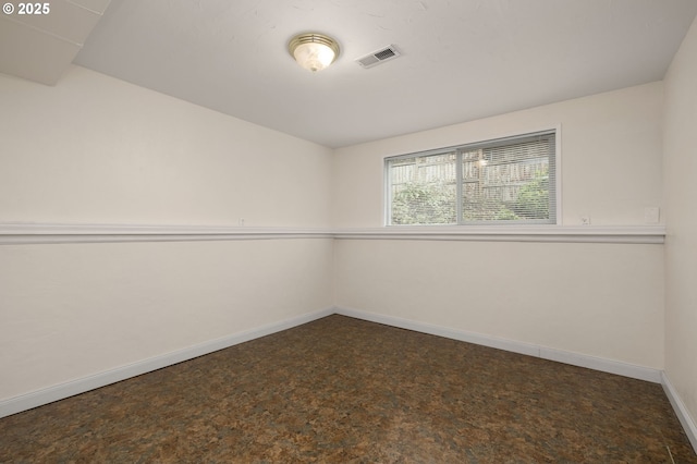 empty room with baseboards and visible vents