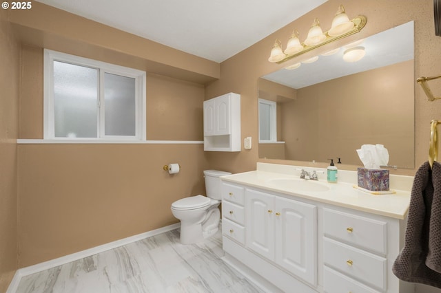 bathroom with baseboards, toilet, and vanity