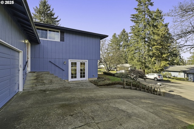 view of patio featuring french doors and a garage