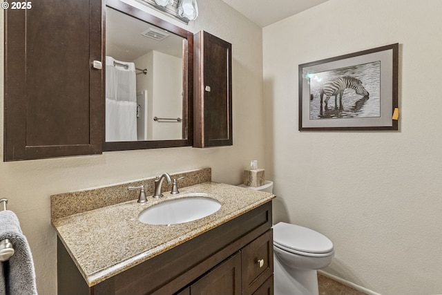 bathroom featuring visible vents, toilet, curtained shower, and vanity