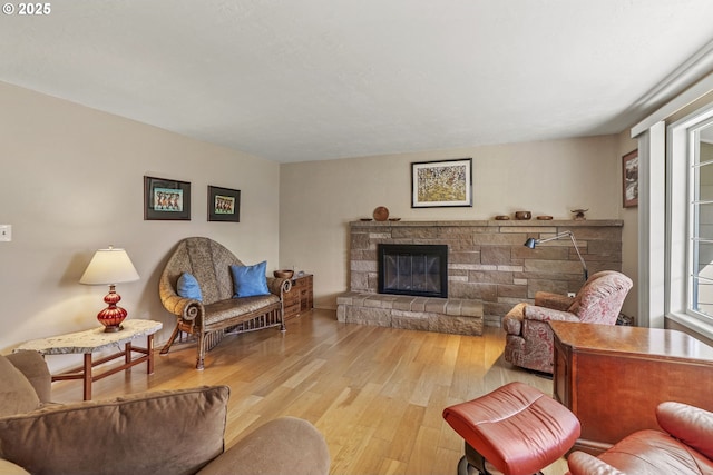 living area with wood finished floors and a fireplace