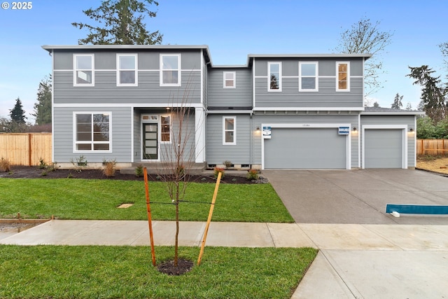 view of front facade featuring a front lawn, concrete driveway, fence, and an attached garage